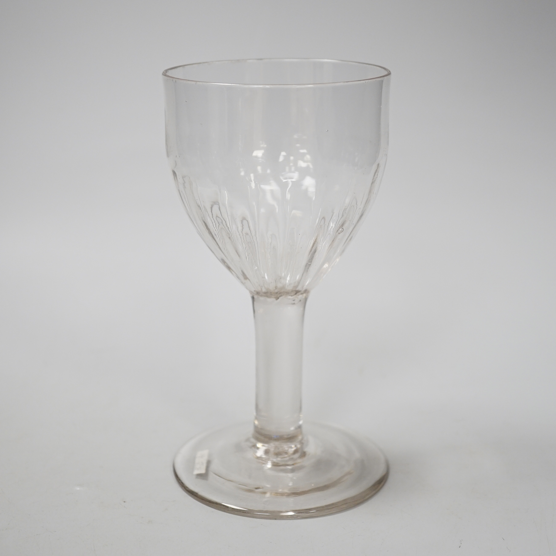 An English lead crystal flute moulded goblet, c,1740-50, a rare form with the lower half of the rounded ovoid bowl moulded with flutes on a plain stem and plain foot, 16.7cm high